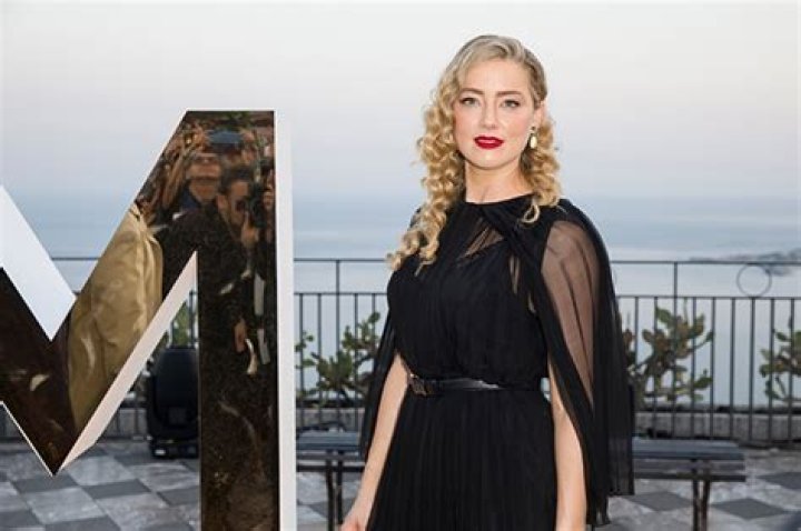 Amber Heard Walks With a Cane in Rare Photos with Daughter Oonaugh Paige, 2, in Spain