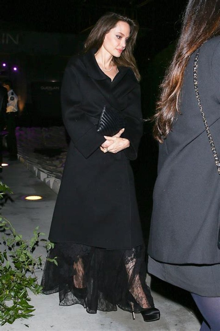 Angelina Jolie Stuns In Lacy Black Dress Under Long Coat While Leaving Event In L.A.
