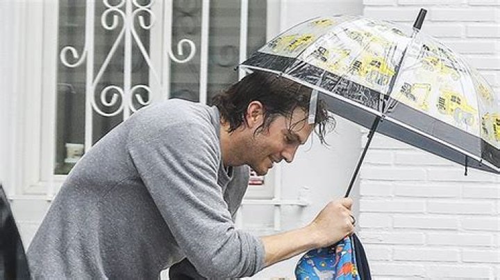 Ashton Kutcher Hilariously Takes Cover Under 3-Year-Old Son Dimitri’s Umbrella During LA Rainfall