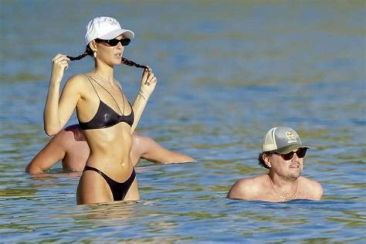 Bella Hadid Frolics On The Beach & Shows Off Amazing Abs In Denim Bikini 