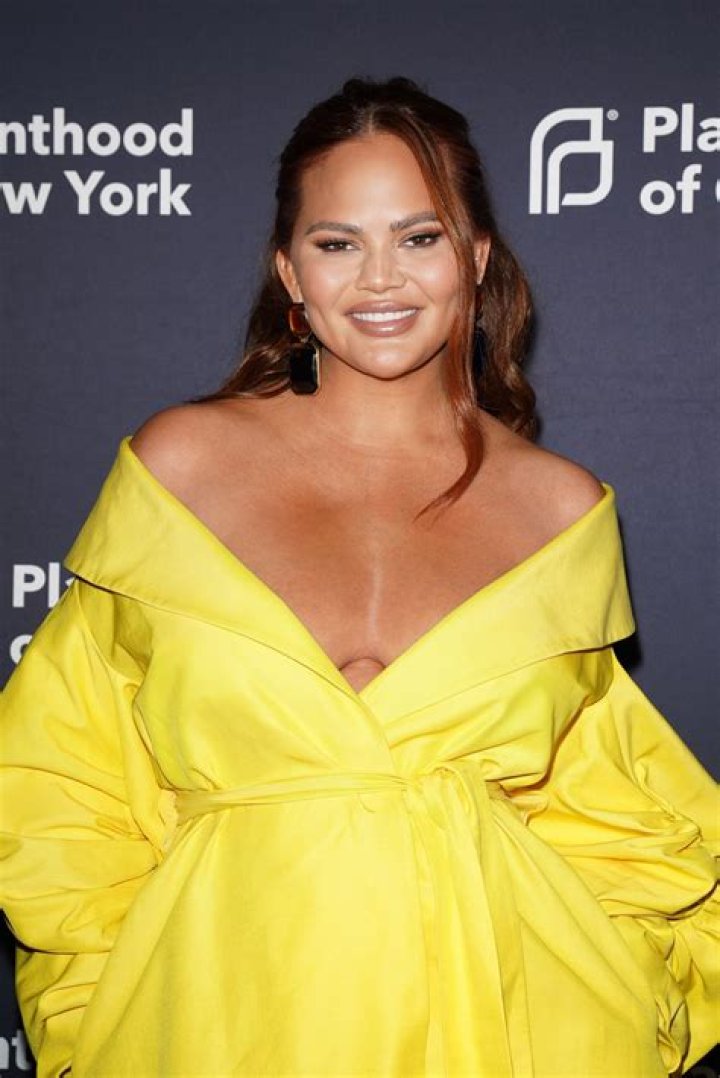 Chrissy Teigen Flaunts ‘Freaky’ Skin-Implanted Feathers & Fans Freak On Twitter — Pics