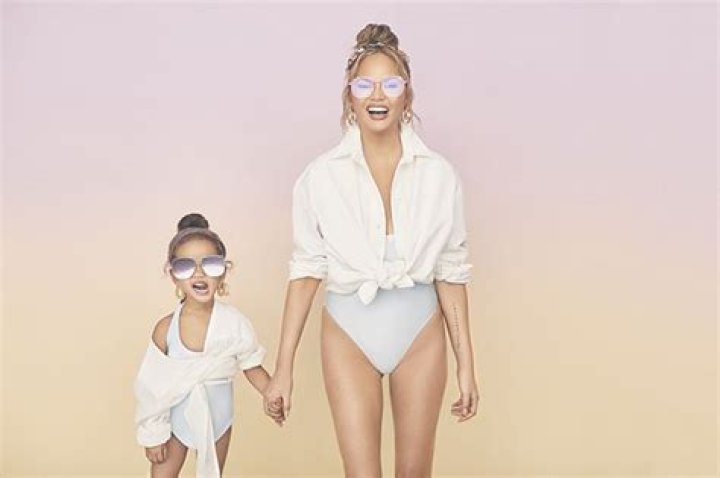Chrissy Teigen, 34, Twins With Daughter Luna, 3, In Cute White One-Piece Bathing Suits & Sunglasses