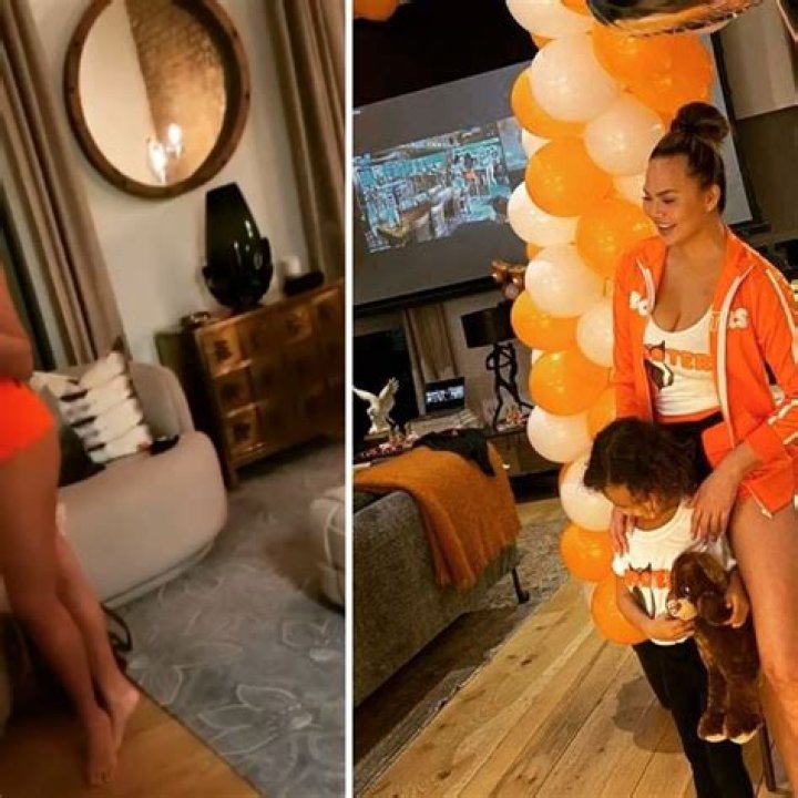 Chrissy Teigen Dresses As A Hooters Girl In Tank & Short Shorts As She Reveals She Once Worked There