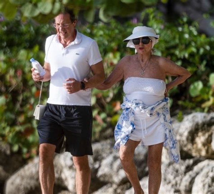 Joan Collins Sunbathing With Husband Percy Gibson On Vacation: Photos – Hollywood Life