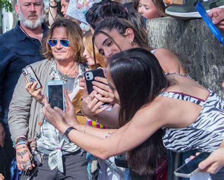 Johnny Depp Smiles & Takes Photos With Large Group Of Female Fans In Germany After Amber Heard Trial