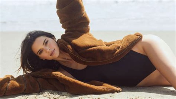 Kendall Jenner Hits The Beach In A Sleek Black Swimsuit & Cozy Fleece As Fall Sneaks Up