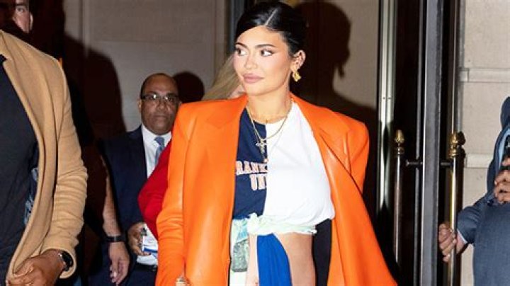 Kylie Jenner Cradles Her Baby Bump & Channels Kim Kardashian In All-Red Look — Watch