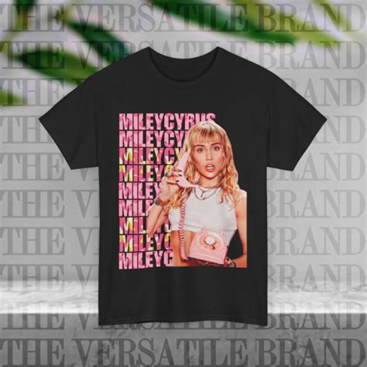 Miley Cyrus Crawls Onto Hood Of Dad’s Truck Wearing Nothing But Heels & T-Shirt – Photo