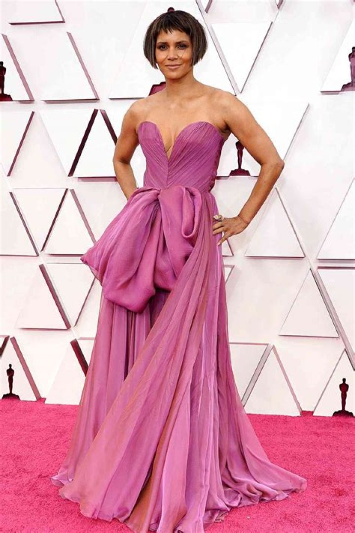Rita Moreno, 89, Stuns In Burgundy Strapless Gown & Matching Coat At 2021 Oscars