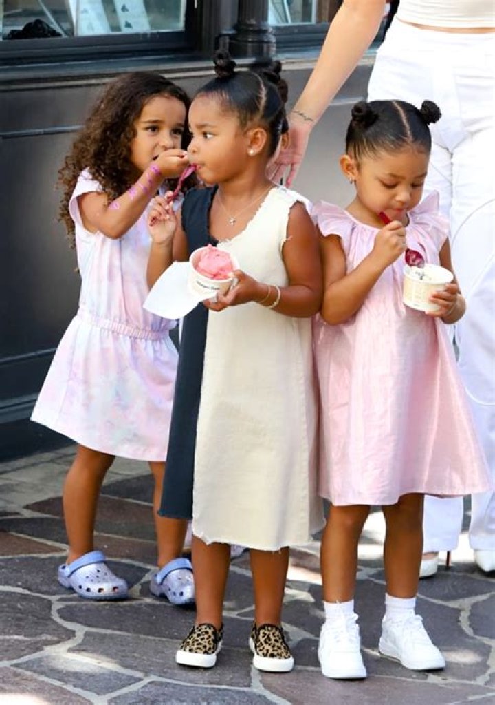 True Thompson, 2, & Stormi Webster, 3, Hold Hands & Go For A Stroll In Cute Summer Dresses